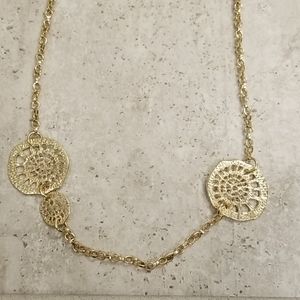 Gold tone medallion chain necklace.